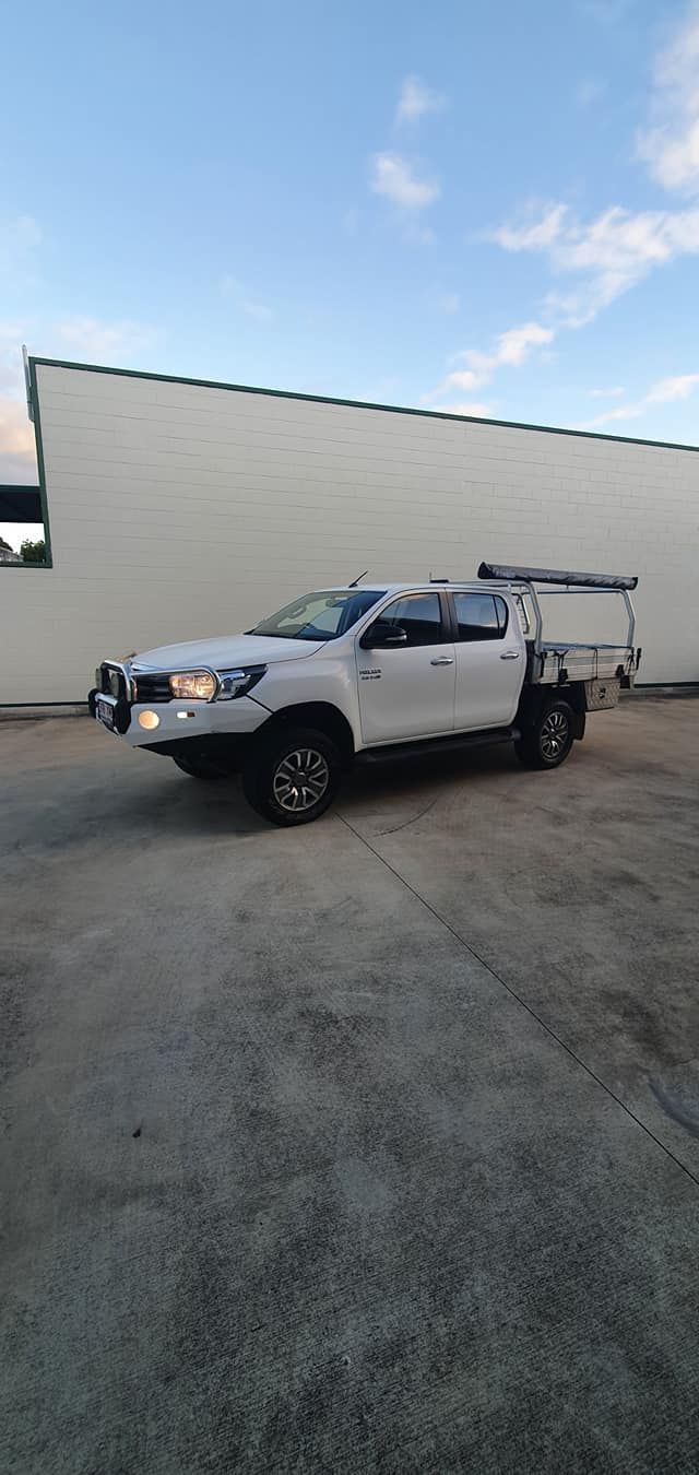 A White Truck Is Parked In A Parking Lot In Front Of A Building — MTM Automotive in Bentley Park, QLD