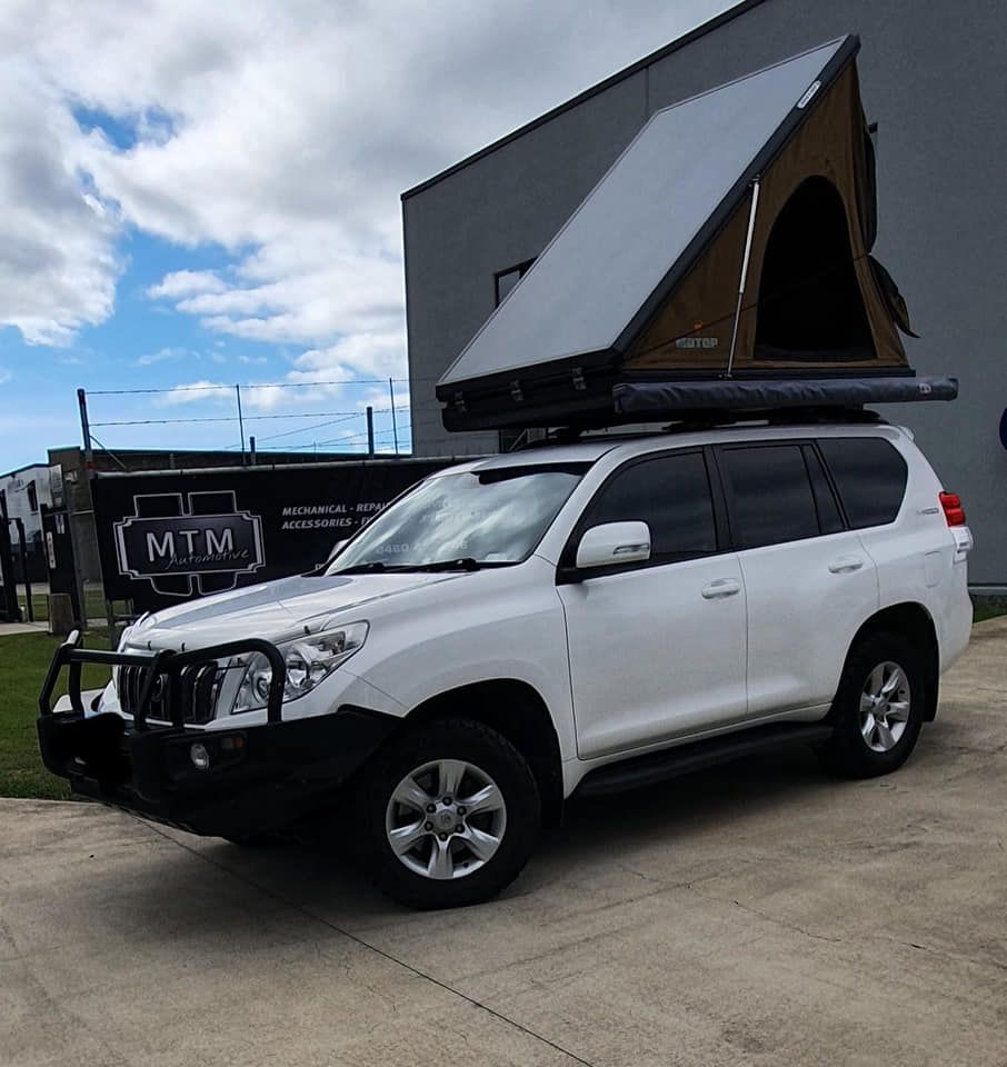 A White Suv With A Tent On Top Of It — MTM Automotive in Bentley Park, QLD