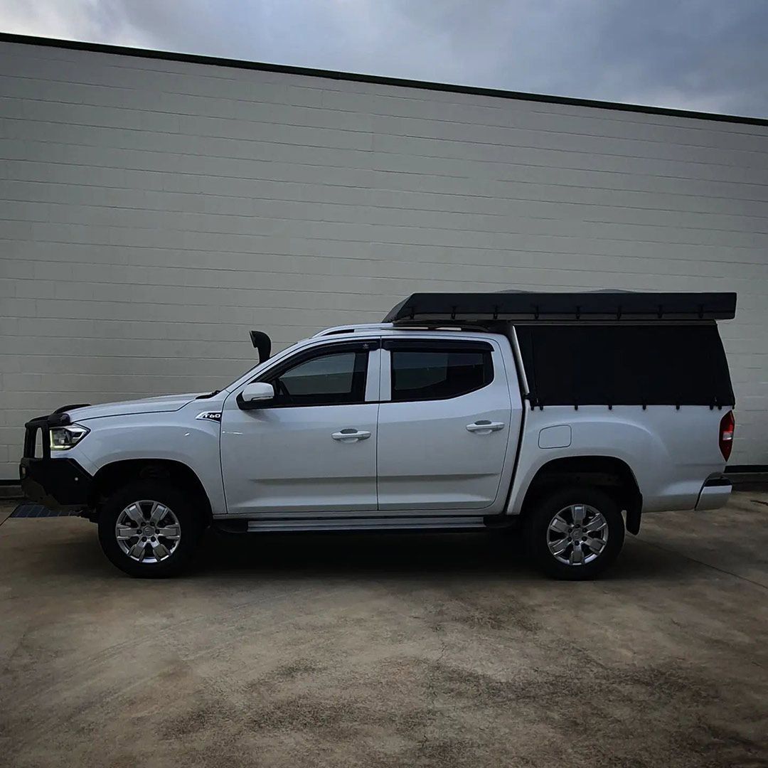 A White Truck With A Black Canopy Is Parked In Front Of A Building — MTM Automotive in Bentley Park, QLD