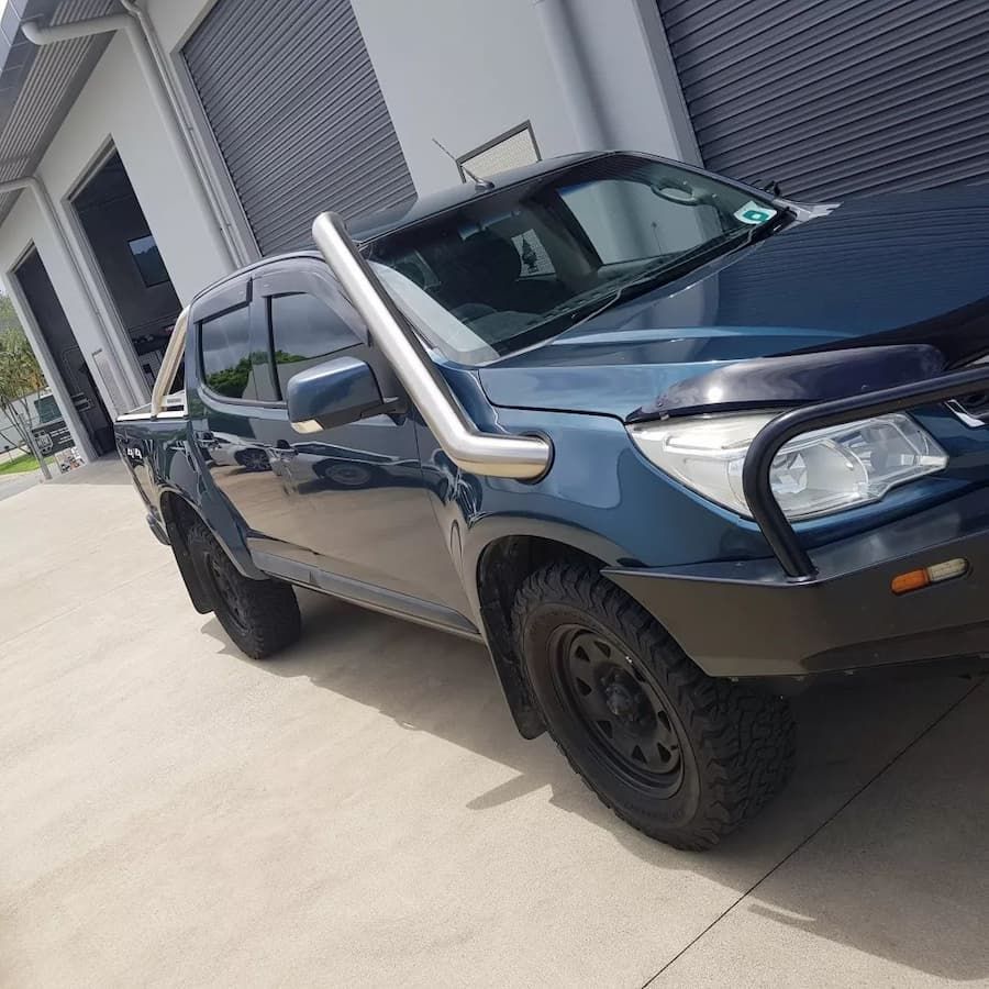 A Blue Truck With A Snorkel On The Hood Is Parked In Front Of A Building — MTM Automotive in Bentley Park, QLD
