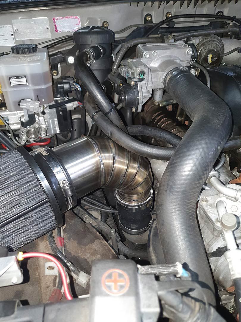 A Close Up Of A Car Engine With A Filter On It — MTM Automotive in Bentley Park, QLD