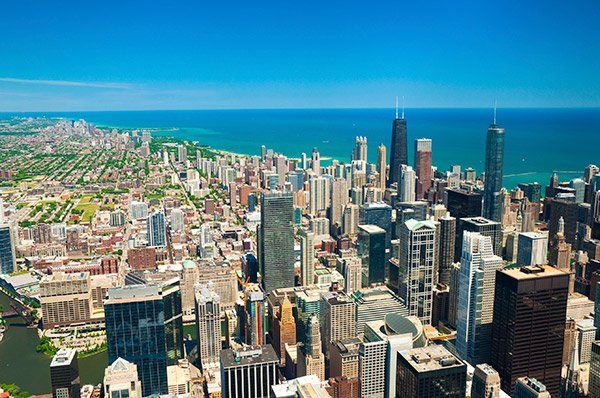 An aerial view of Chicago's skyline with Lake Superior in the background.
