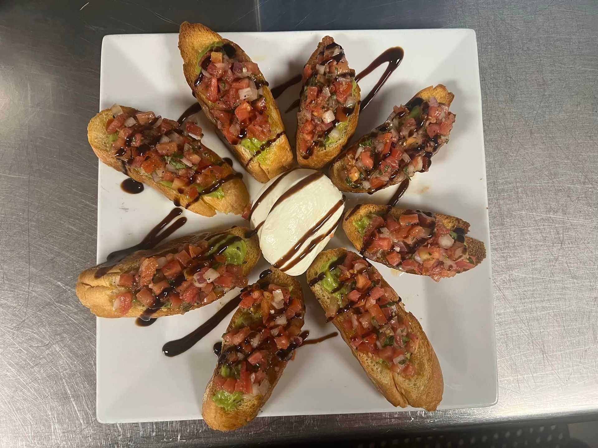 A white plate topped with a bunch of food on a table