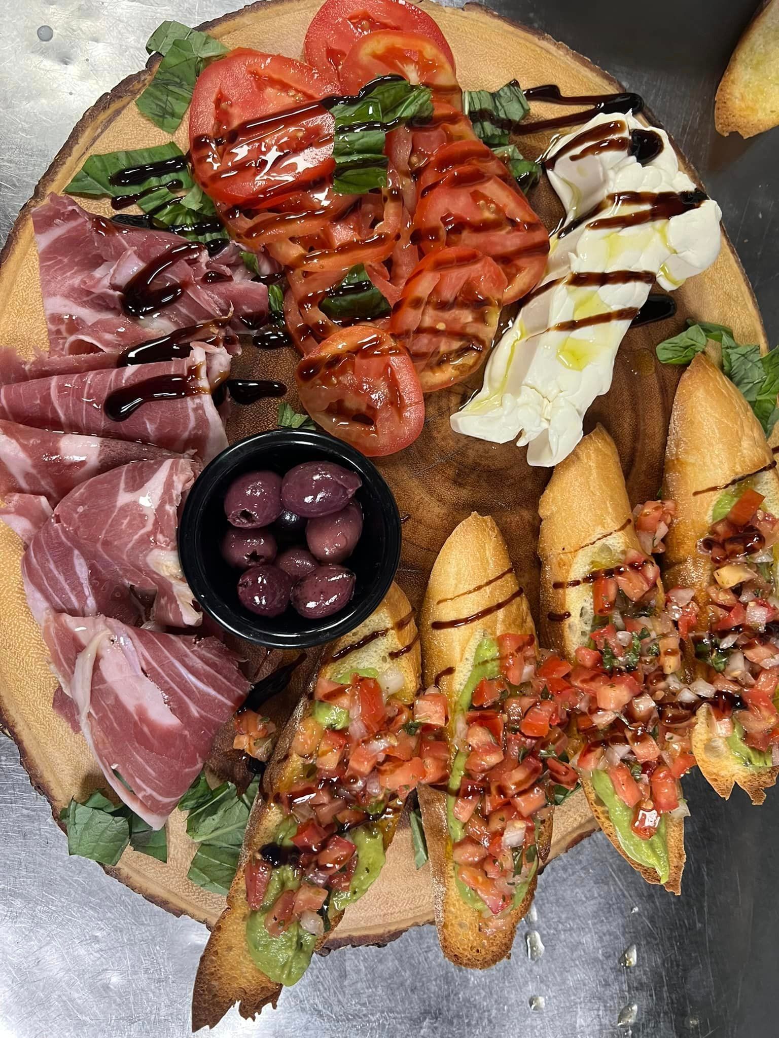 A wooden cutting board topped with a variety of food.
