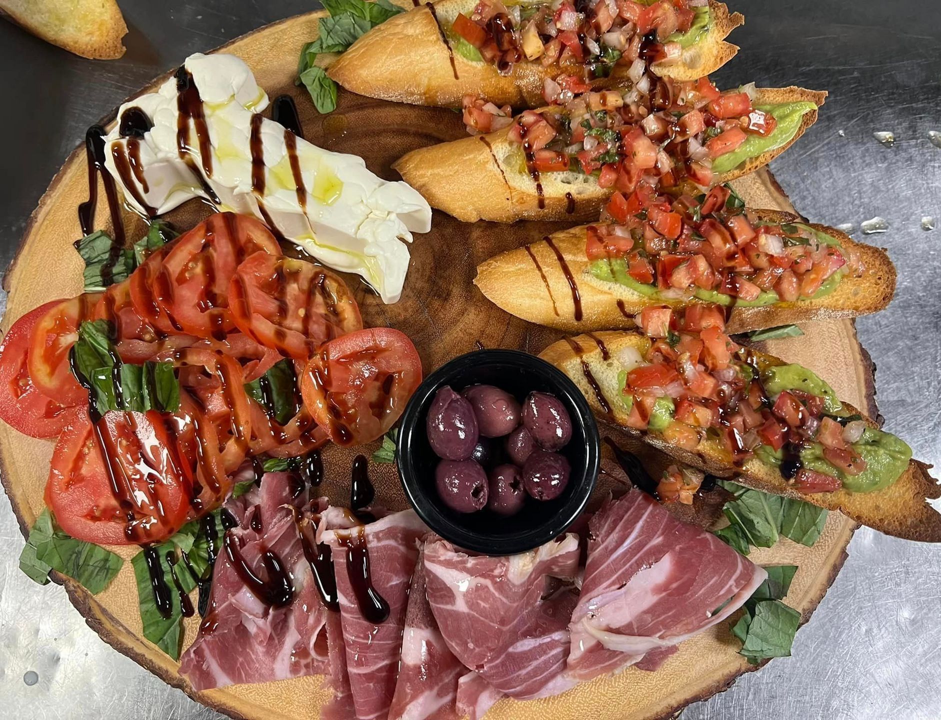A wooden cutting board topped with a variety of food.