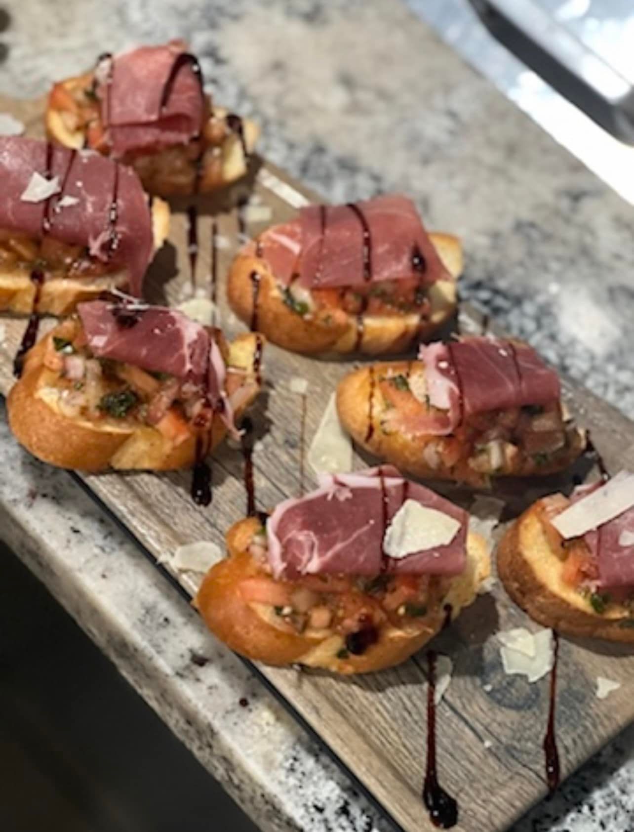 A wooden cutting board with a bunch of food on it