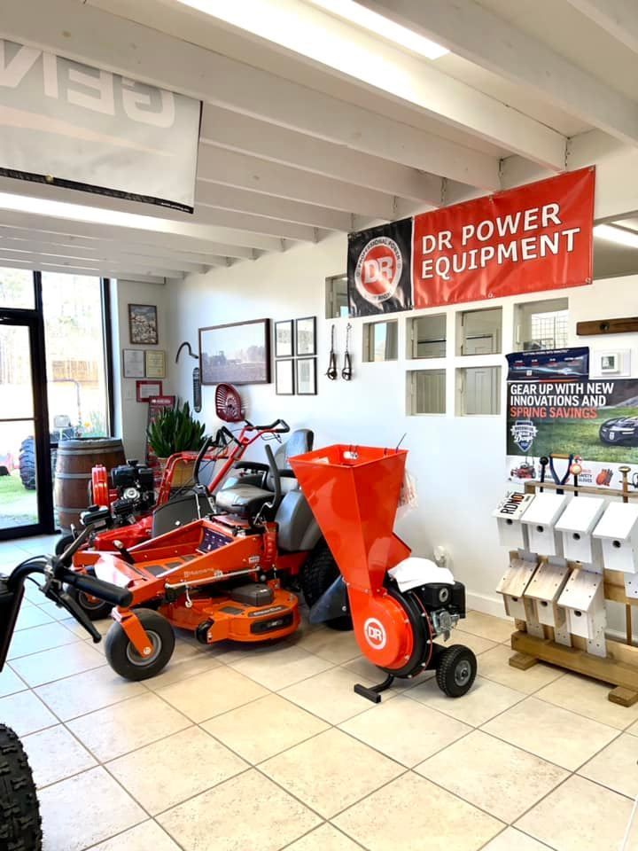 A showroom filled with lawn mowers and a sign that says `` dr power equipment ''.