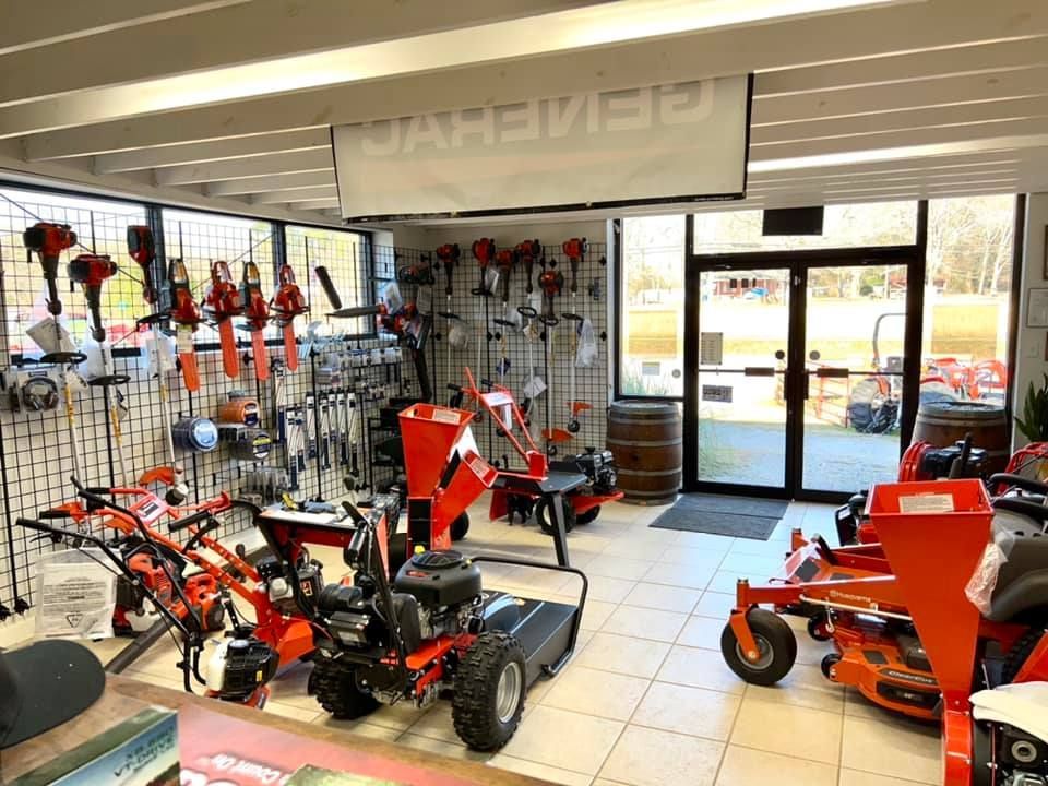 A store filled with lots of lawn mowers and tractors.