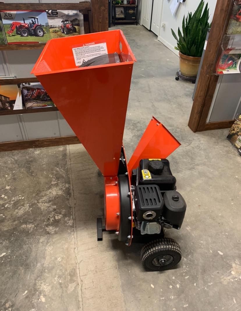 A small orange machine is sitting on the floor in a room.