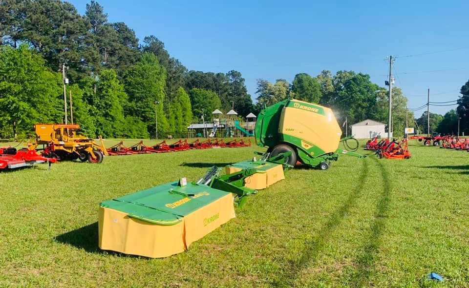 A bunch of tractors are parked in a grassy field.