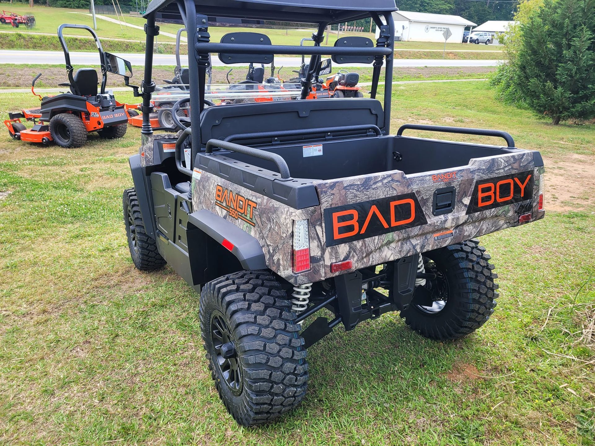 A bad boy utility vehicle is parked in a grassy field.