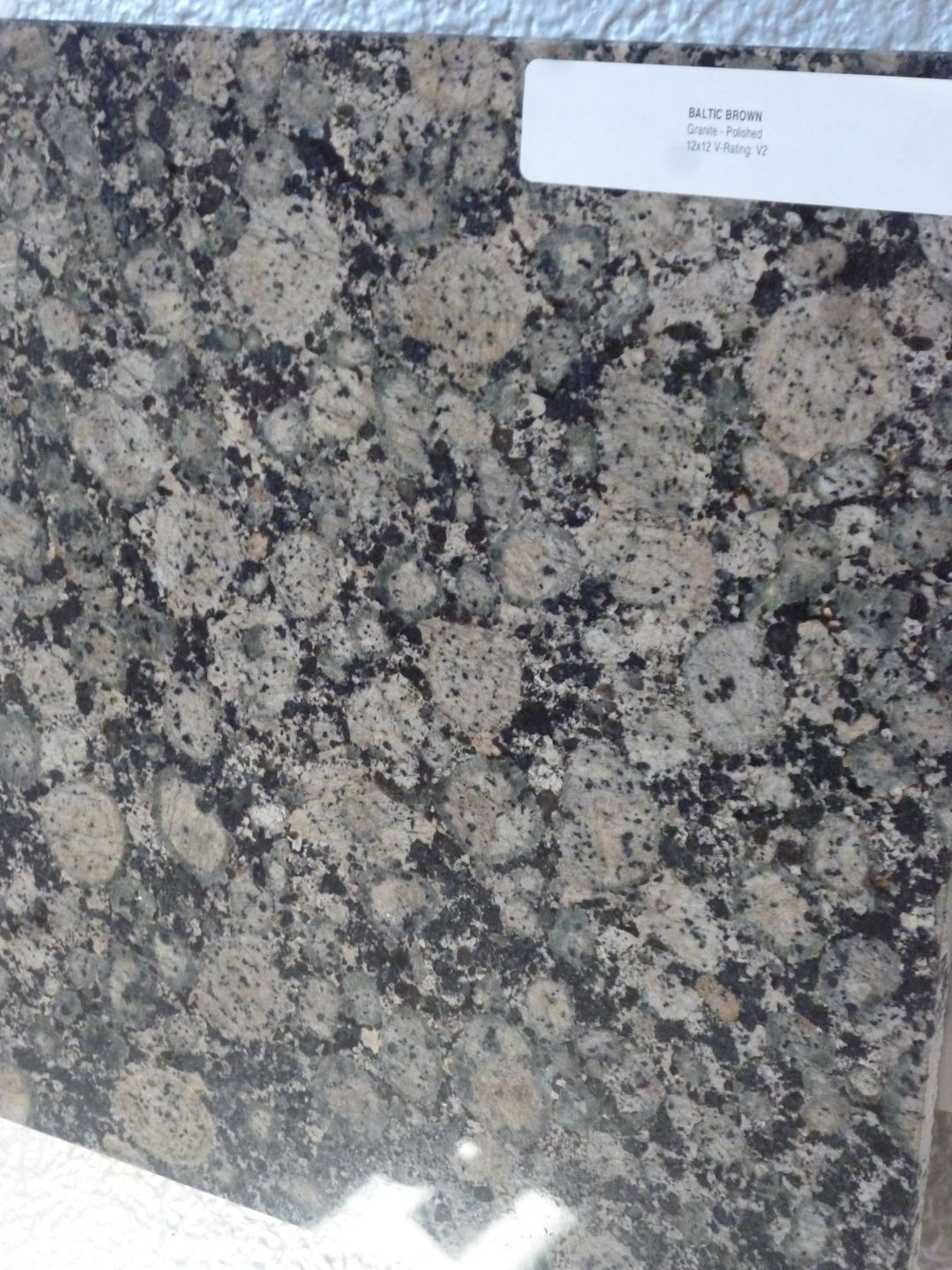 A close up of a piece of granite with a label on it.