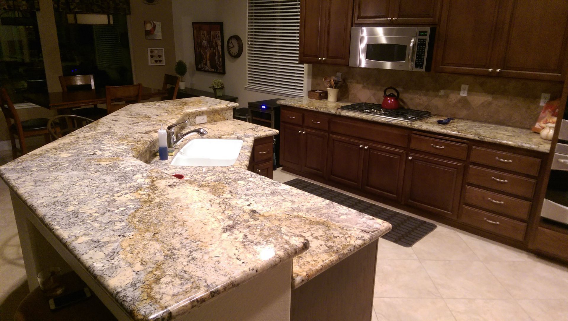 A kitchen with granite counter tops and wooden cabinets