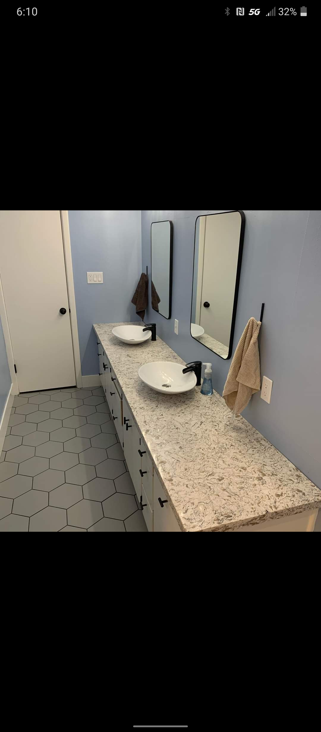A bathroom with two sinks and two mirrors.