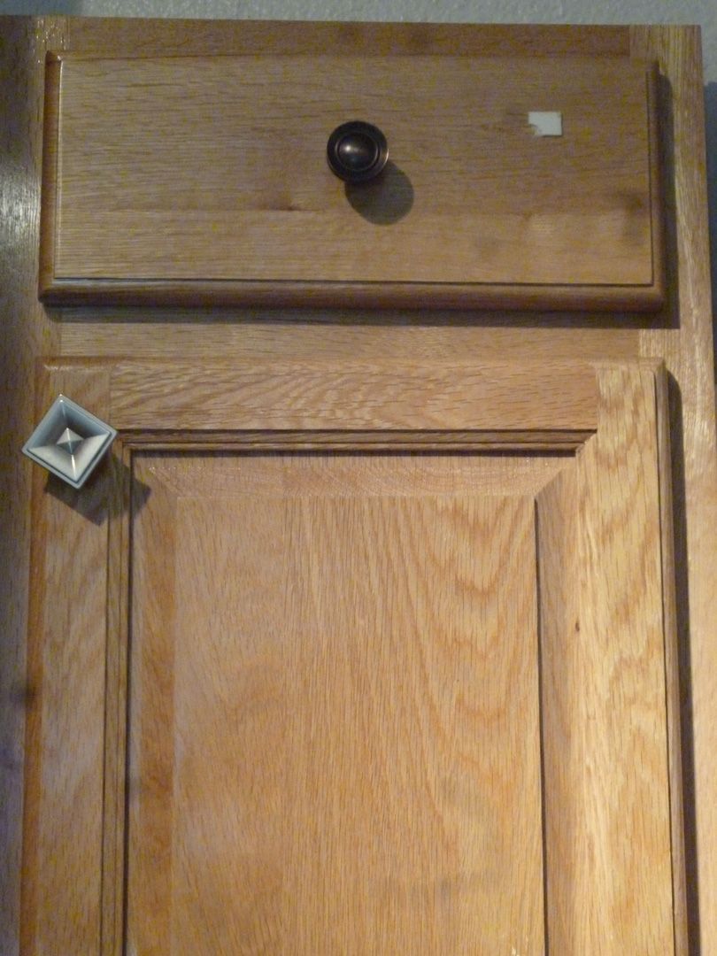 A wooden cabinet with a drawer on top of it.