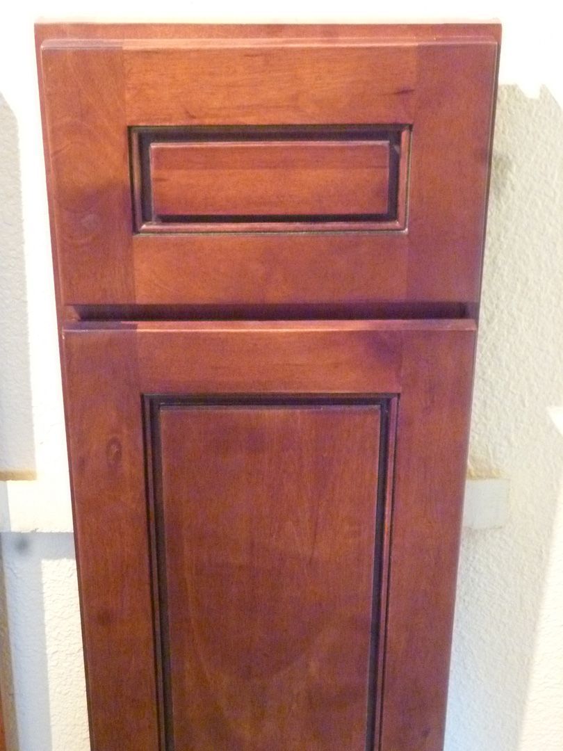 A wooden cabinet with a drawer underneath it