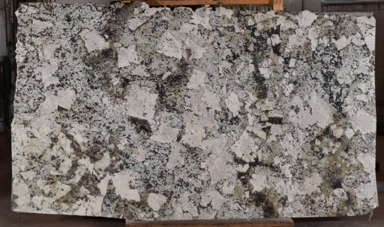 A piece of granite is sitting on a wooden shelf.