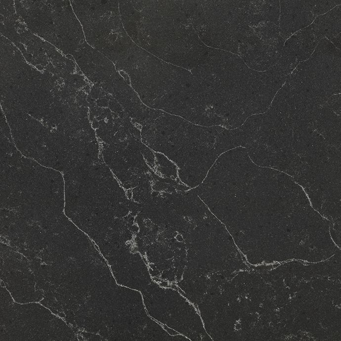 A close up of a black marble counter top with white veins
