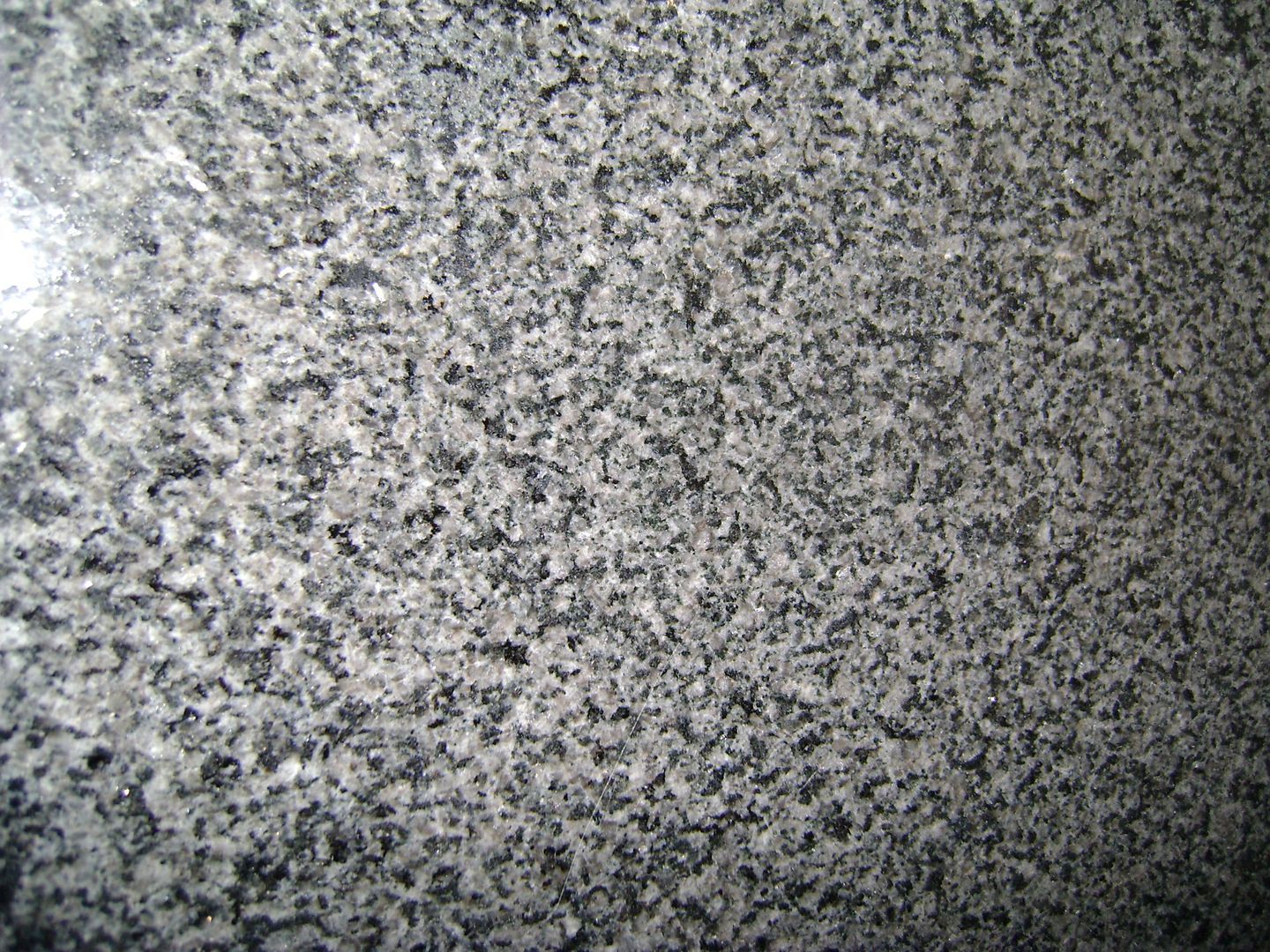 A close up of a black and white granite counter top.