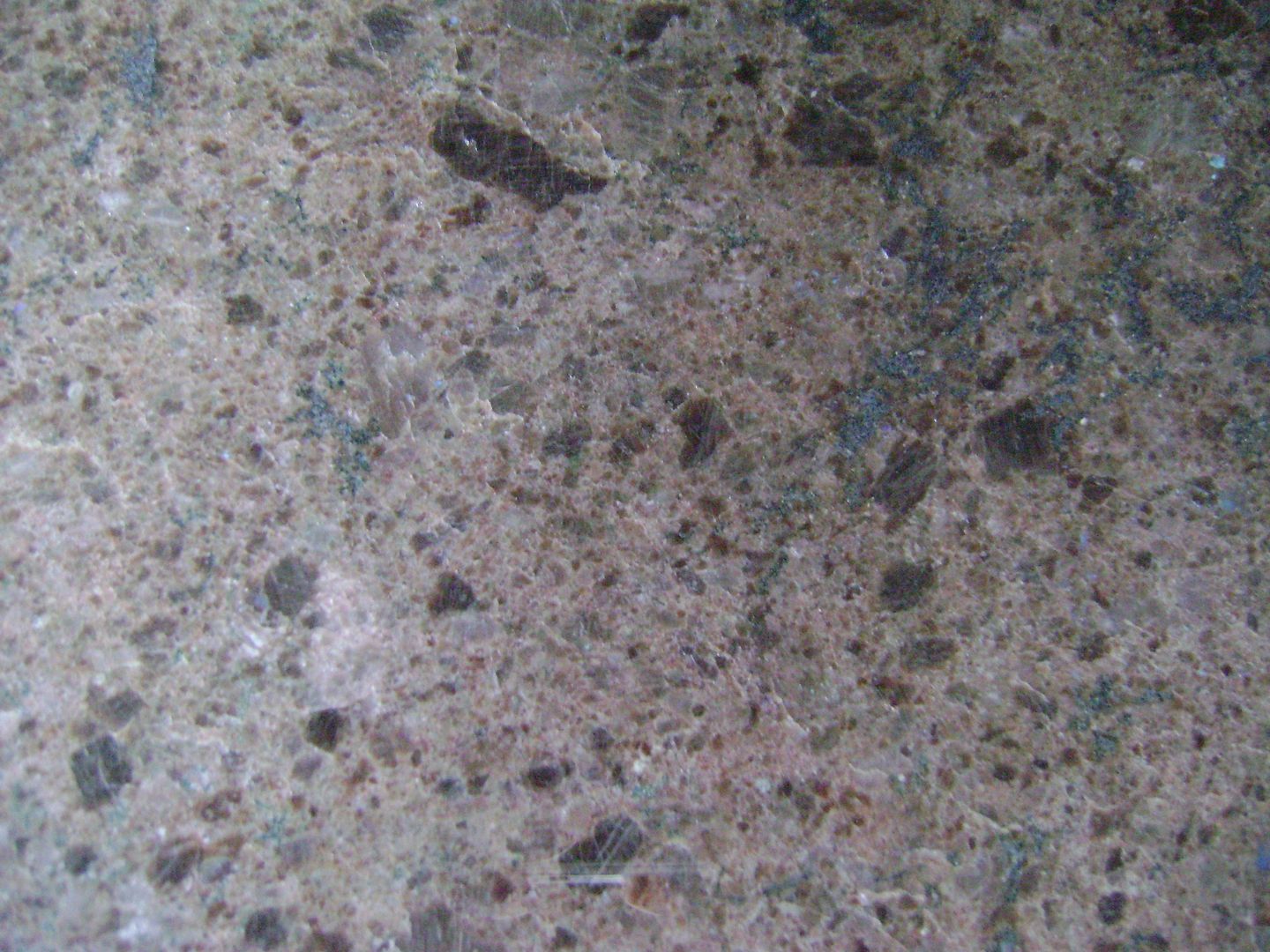 A close up of a granite counter top with a lot of small rocks on it.