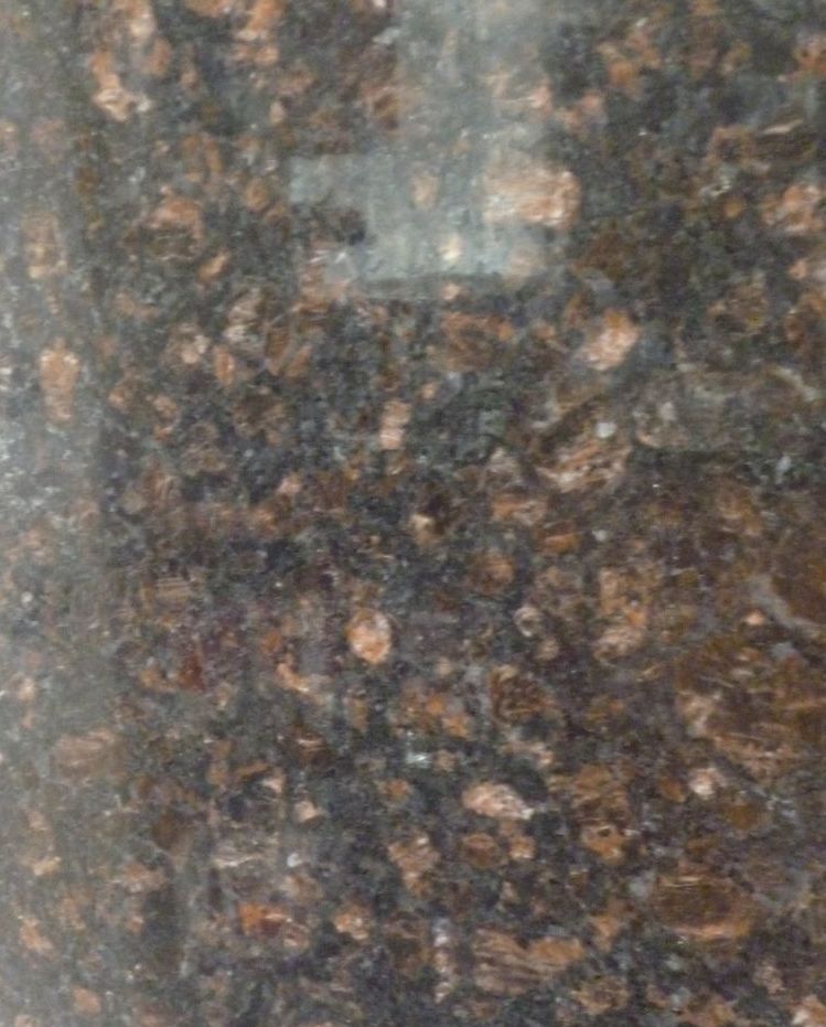 A close up of a brown granite counter top.