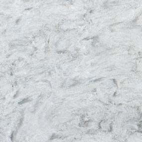 A close up of a white marble counter top.