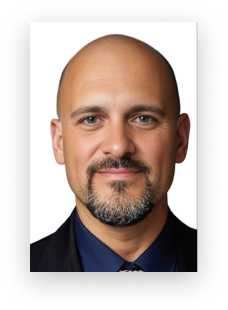 A bald man with a beard wearing a suit and blue shirt