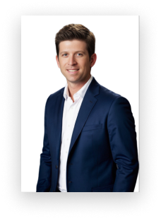 A man in a blue suit and white shirt is smiling