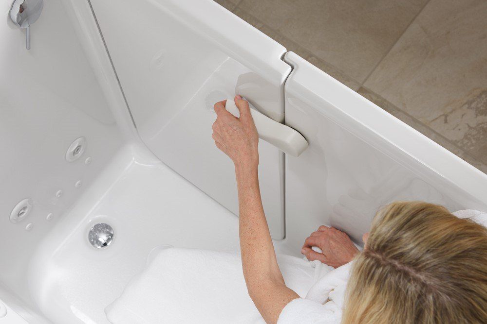 Woman Using New Bathtub — Moline, IL — Midwest Bath Co.