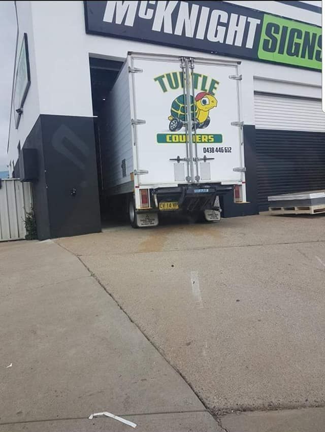 White Truck With a Turtle on the Back is Parked in Front of a Building - Turtle Couriers in Tamworth, NSW