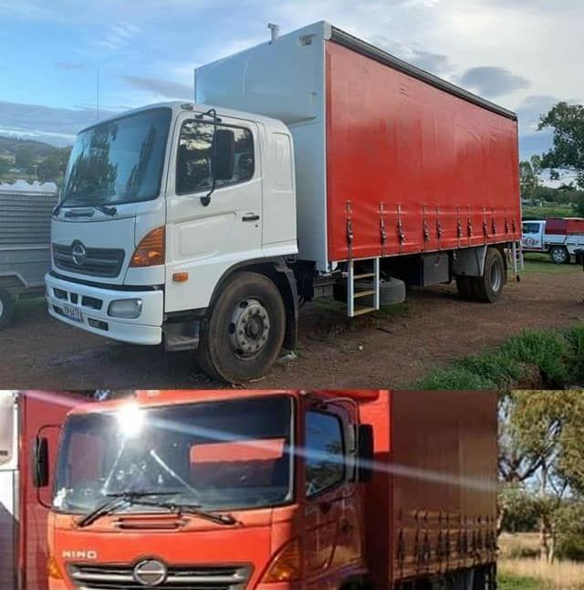 Red Truck is Parked Next to a White Truck in a Parking Lot - Turtle Couriers in Tamworth, NSW