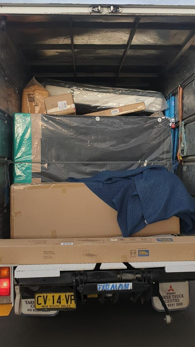 Back of a Truck Filled With Boxes and Mattresses - Turtle Couriers in Tamworth, NSW