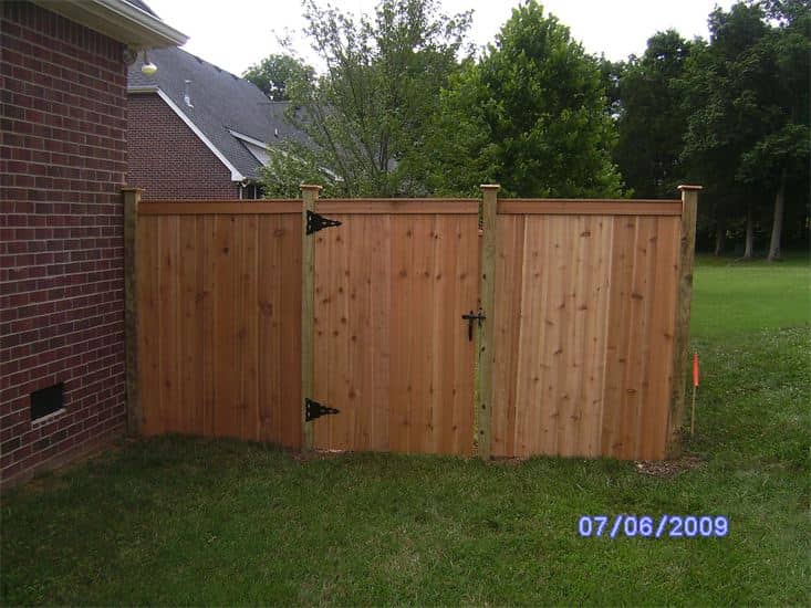 Wooden Fence In Residential House With Trees — Madison, TN — Music City Fence Company