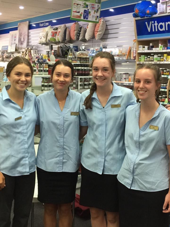 A group of young women are posing for a picture in a store