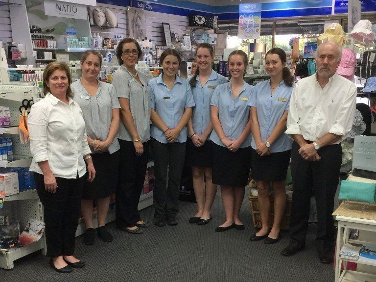 A group of people are posing for a picture in a store.