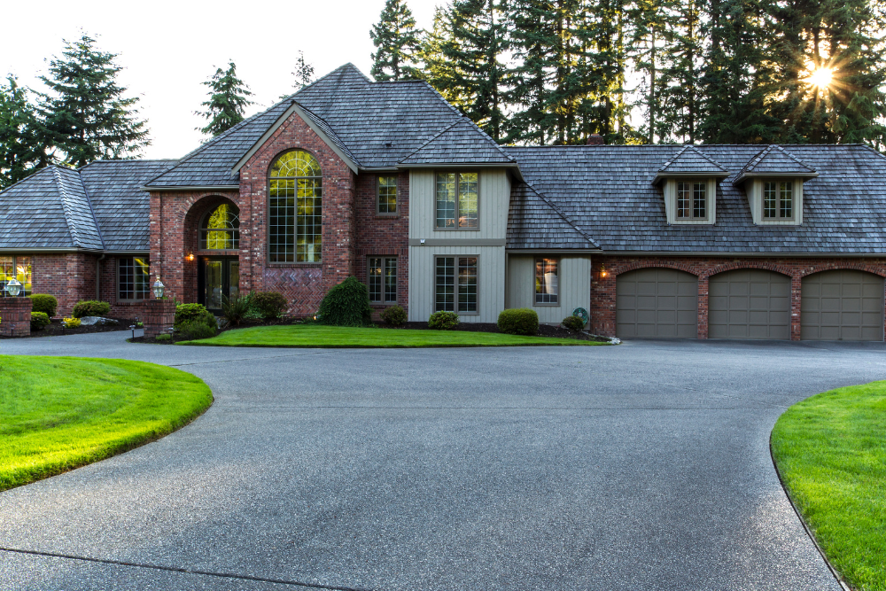 A large brick house with a driveway leading to it