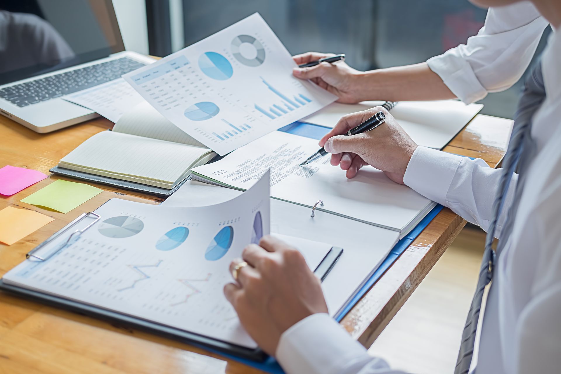 Two people reviewing financial charts