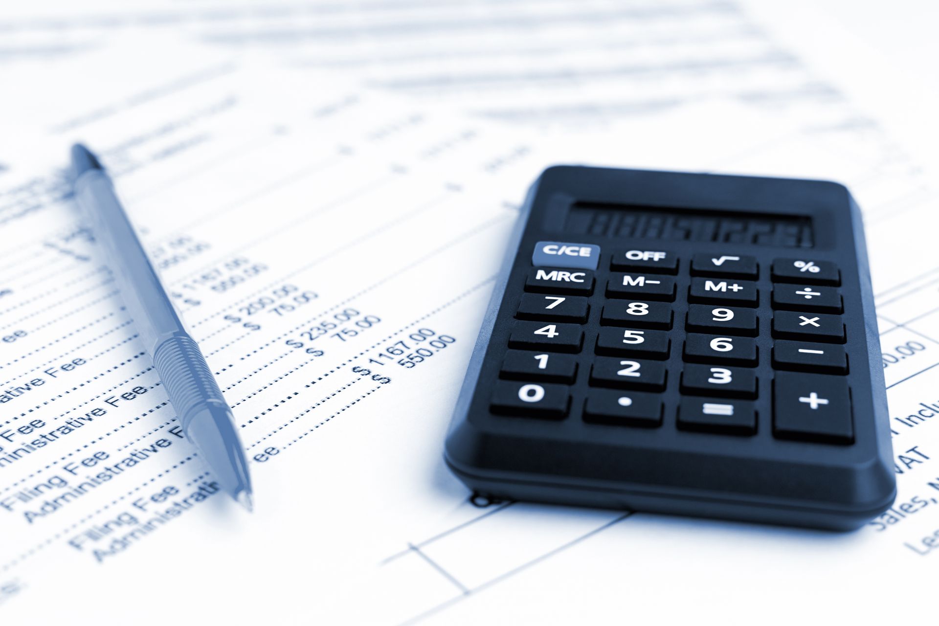 Calculator and pen on financial documents