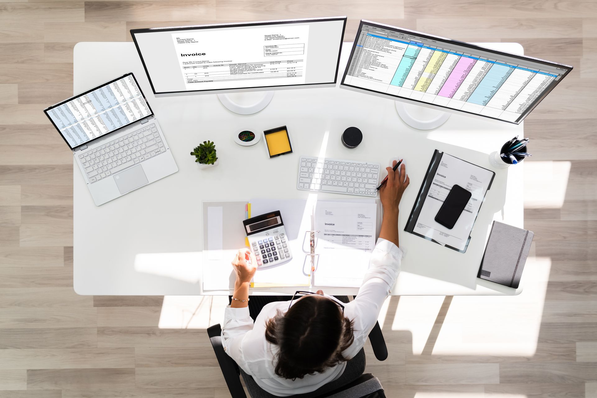 Overhead view of person at desk with computer screens
