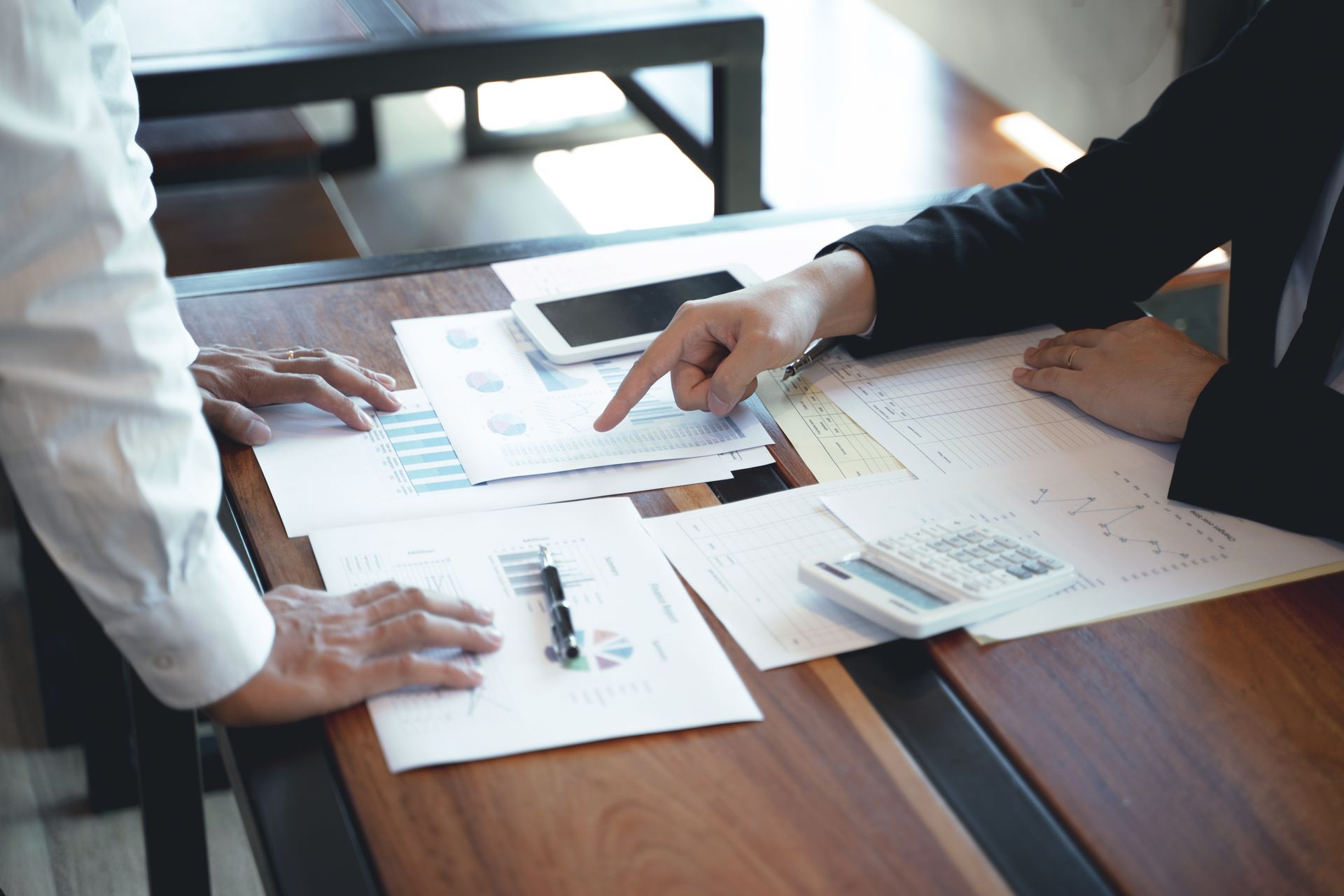 Two people review financial documents 