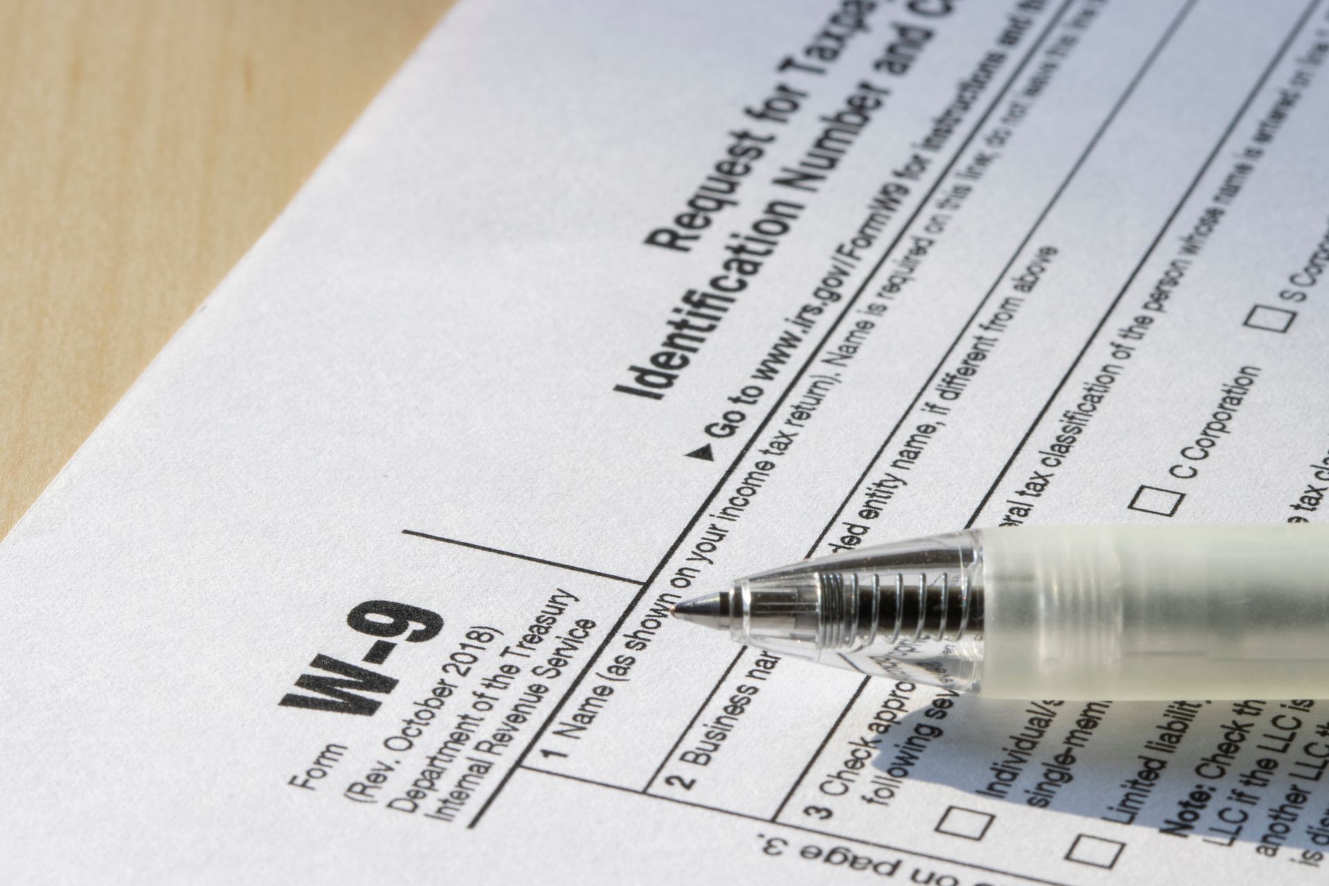 W-9 tax form with a pen resting on it
