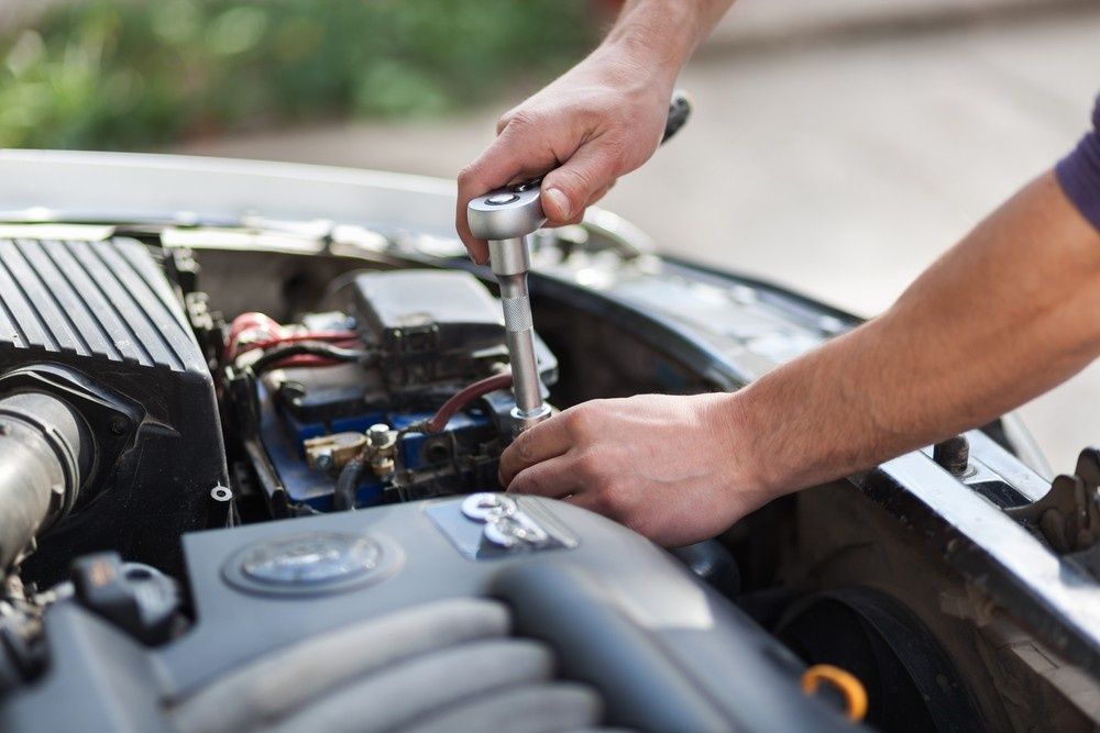 A Mechanic Using a Wrench to Work on A Car Engine — BEB Automotive In Sutherland, NSW