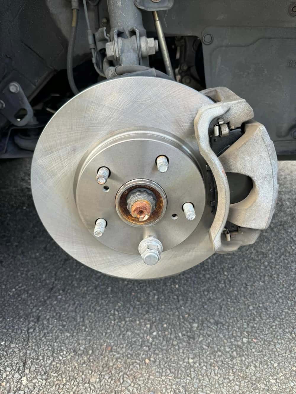A Close up Of A Brake Disc on A Car — BEB Automotive In Shellharbour, NSW