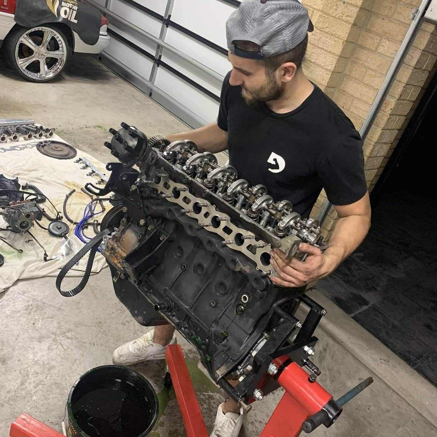 A Man Is Working on A Car Engine in A Garage — BEB Automotive In Liverpool, NSW