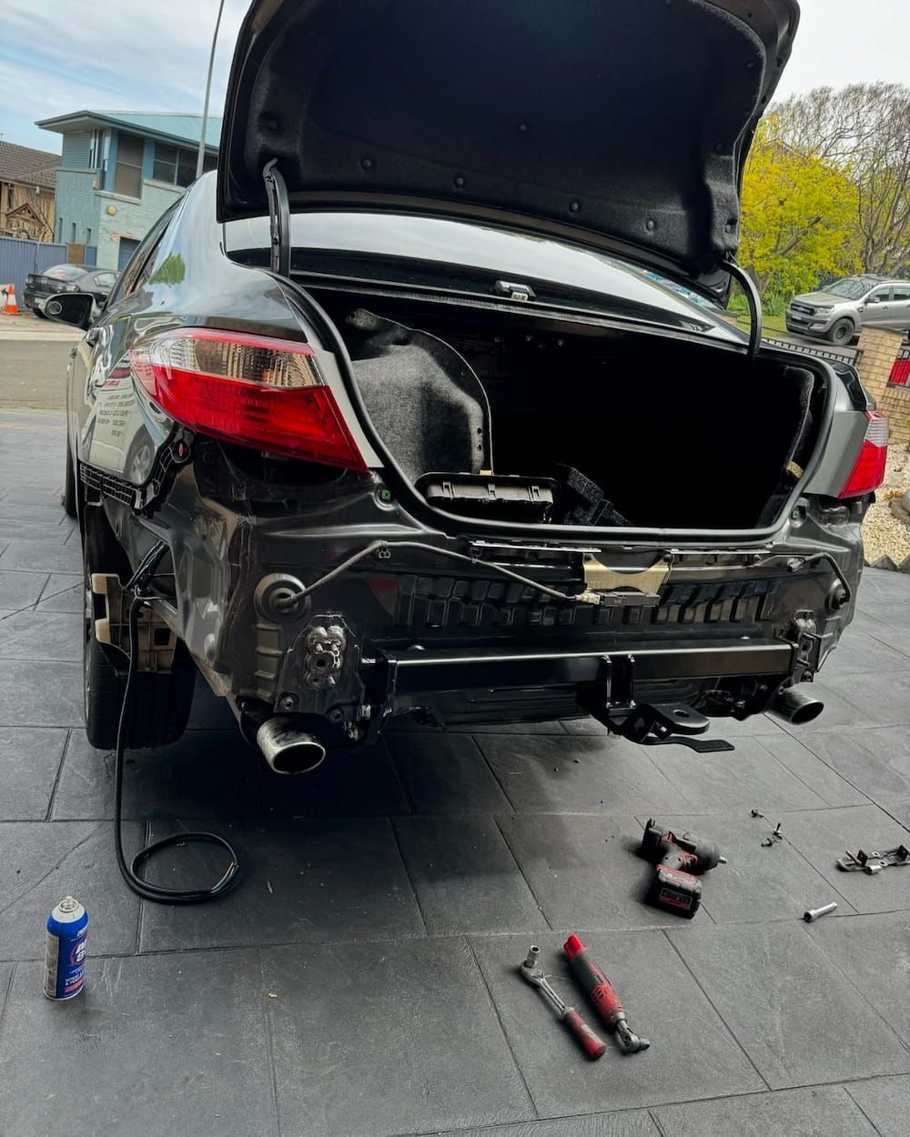 A Black Car with The Trunk Open Is Being Repaired — BEB Automotive In Nowra, NSW