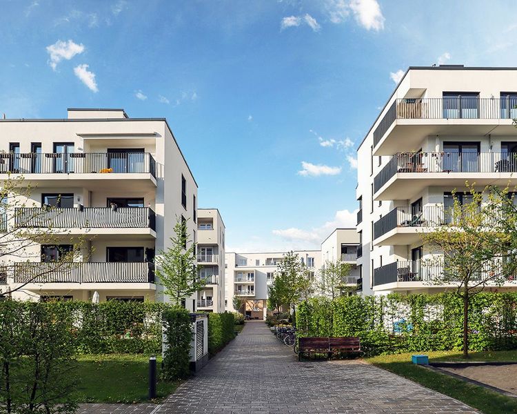 A row of apartment buildings with balconies in a residential area.