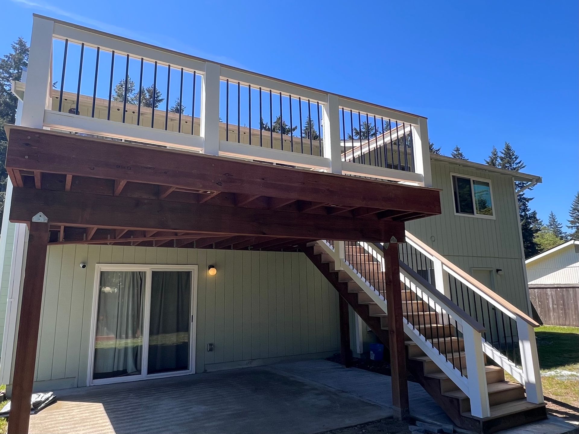 A house with a large deck and stairs leading up to it.