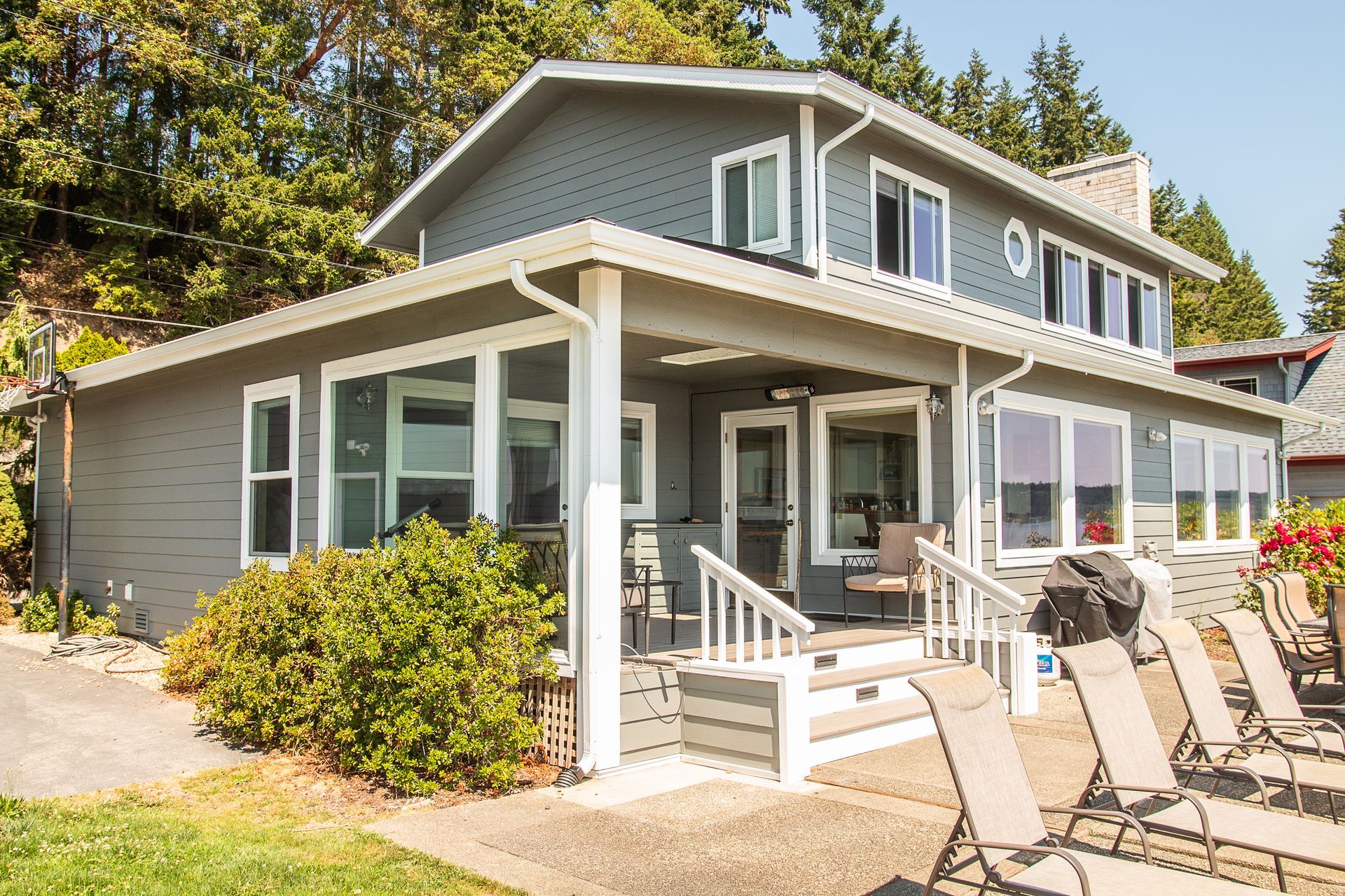 A large house with a lot of windows and chairs in front of it.