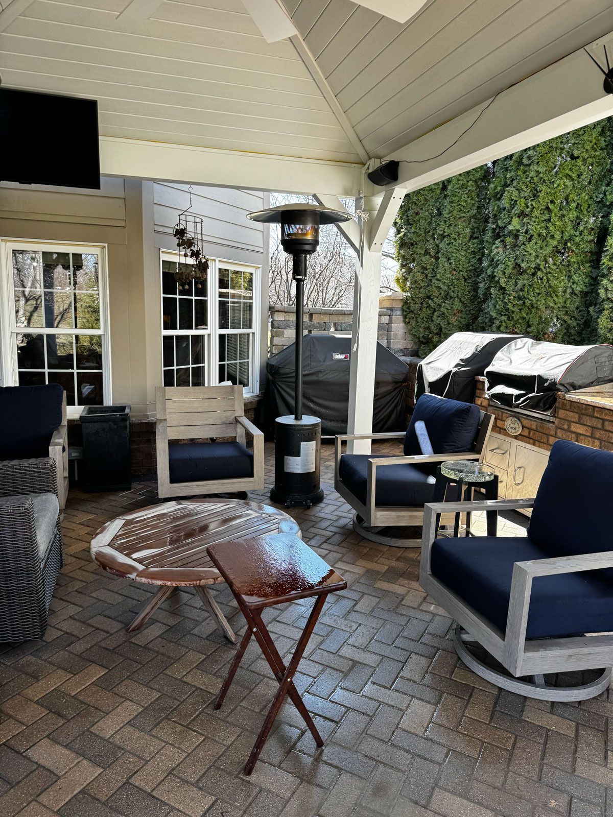 A person is using a high pressure washer to clean a patio.