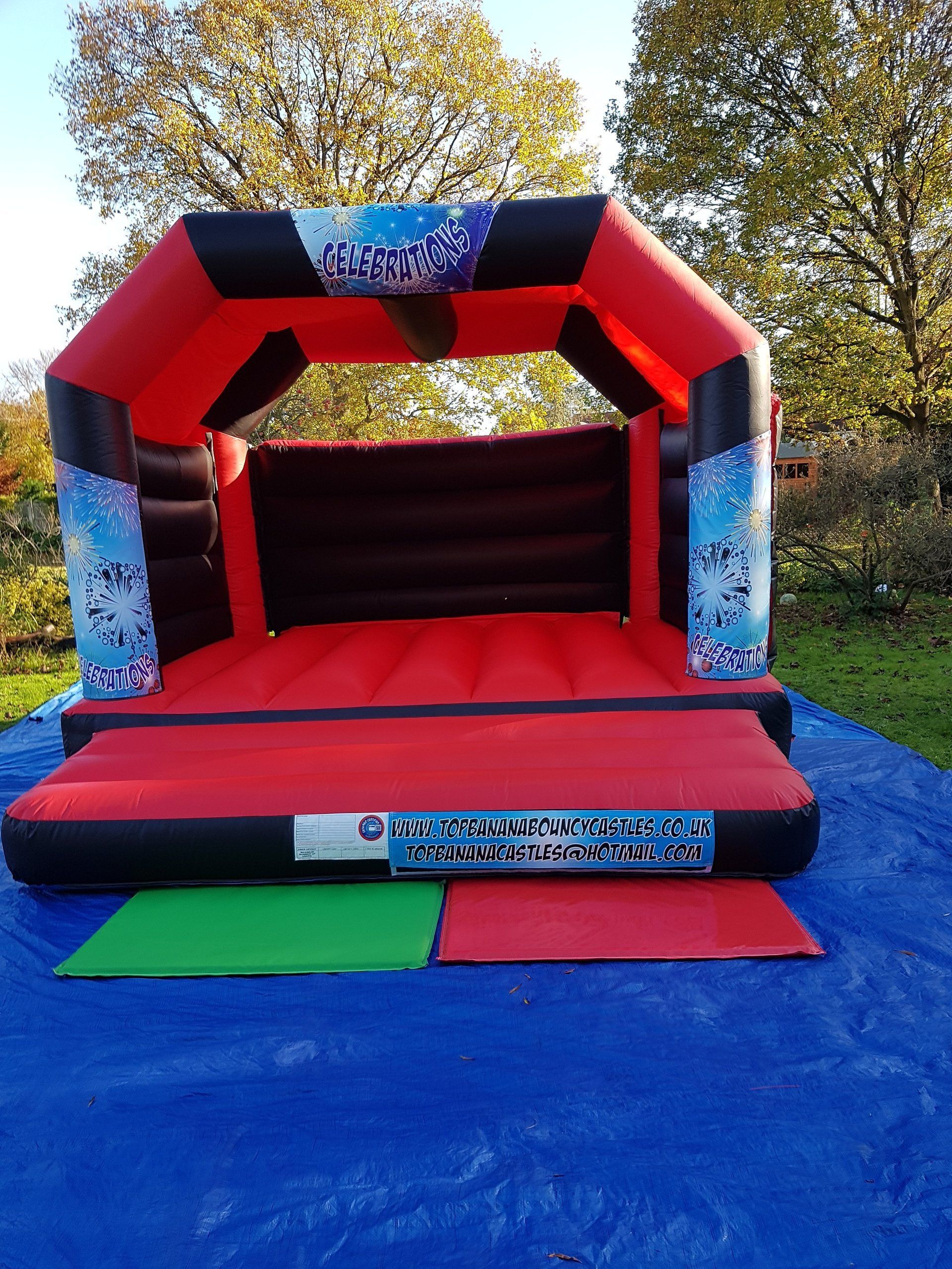 red and black adult bouncy castle with celebration artwork